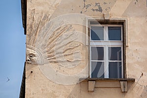 A bas-relief depicting the sun on the wall of a building in the center of Nysa.