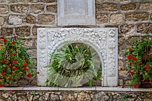 Bas-relief and flowers, courtyard of the Greek Orthodox Wedding Church in Cana, Israel.