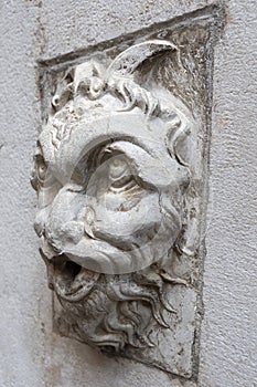 Bas-relief head positioned on a fountain located in Cortile Federico II - Piazza del Comune, Cremona photo
