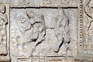 Bas-relief of Maestro Nicolo` 12th century, group to the right of the door of the Basilica of St Zeno in Verona, Italy photo