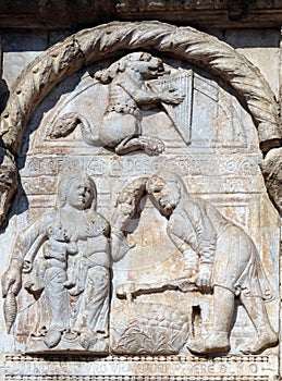 Bas-relief of Maestro Nicolo` 12th century, group to the right of the door of the Basilica of St Zeno in Verona photo