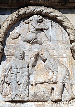 Bas-relief of Maestro Nicolo` 12th century, group to the right of the door of the Basilica of St Zeno in Verona photo