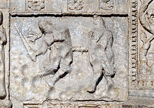 Bas-relief of Maestro Nicolo` 12th century, group to the right of the door of the Basilica of St Zeno in Verona photo