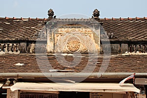 bas-relief on the roof of an habitation building in luang prabang (laos)