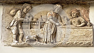 Bas-relief showing a medieval bakery shop photo