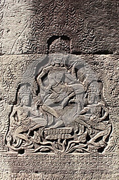 Bas-relief of three dancers in the temple of Angkor wat