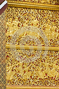 The bas-relief on the wall of the temple in Louangphabang, Laos. Close-up. Vertical.