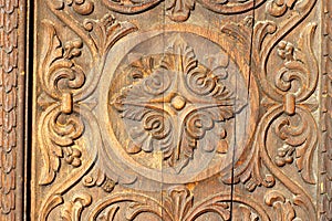 Bas relief in wood - carved wooden door. Wooden background