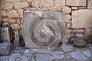 Bas reliefs on the ancient stone. religious patterns carved in stone. christian sign photo