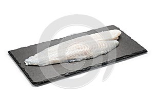 Basa fish fillet on a black stone plate photo