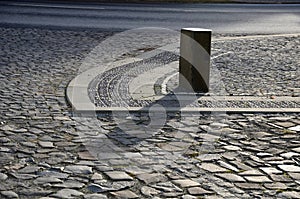 Basalt hexagonal natural column created by the gradual solidification of lava, is used in the city as a safety dividing bollard on photo