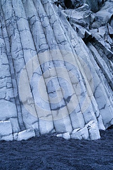 Basalt stones as a background. Reynisfjara Beach, Iceland. Sharp rocks.