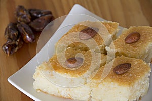 Basbousa with Dates on a Table