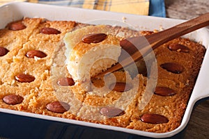 Basbousa pie with almonds macro in a baking dish. Horizontal