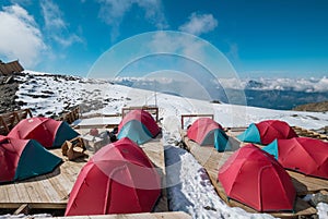 Base camp tents on the classic Mont Blanc Monte Blanco route from France side with a picturesque Apls landscape view. Active peo