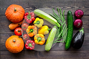 Base of healthy diet. Vegetables pumpkin, paprika, tomatoes, carrot, zucchini, eggplant on dark wooden background top