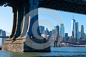 Base of the Manhattan Bridge along the East River with the Lower Manhattan Skyline and Brooklyn Bridge in New York City