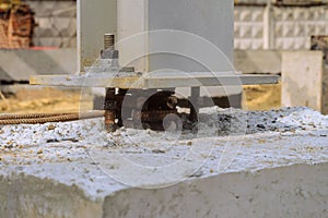 The base of a mounted metal column exposed at the design elevation on a concrete grillage before concreting