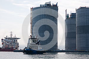 Base of oil platform and tugs