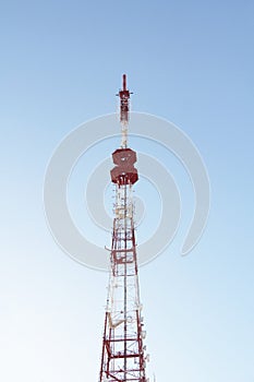 Base station mobile network antenna on a steel structure mast with a repeater.