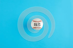 Baseball ball on blue background with the word rules
