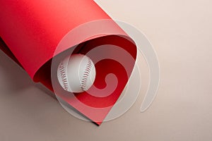 Baseball ball on grey and red background with copy space