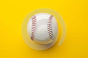 Baseball ball on yellow background with copy space