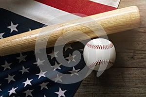 Baseball and baseball bat with American flag in the background