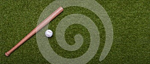 Baseball bat and ball on green grass field.  Sport theme background with copy space for text and advertisment photo