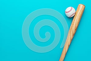 Baseball bat and ball on turquoise blue background