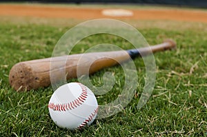 Baseball and Bat on Field photo