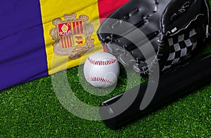 Baseball bat, glove and ball near Andorra flag on green grass background