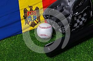 Baseball bat, glove and ball near Moldova flag on green grass background