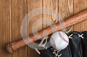 Baseball bat, glove and ball on wooden floor.  Sport theme background with copy space for text and advertisment