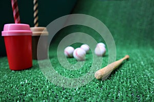 Baseball and bat on the green grass with copy space