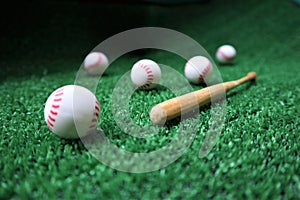 Baseball and bat on the green grass with copy space