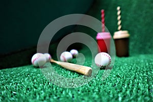 Baseball and bat on the green grass with copy space