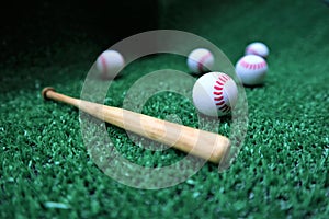 Baseball and bat on the green grass with copy space
