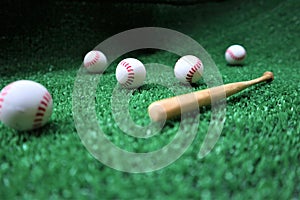 Baseball and bat on the green grass with copy space