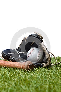 Baseball bat,shoes, glove and ball on green grass field. Sport theme background with copy space for text and advertisment