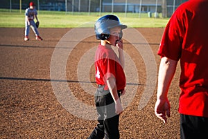 Baseball boy looking at coach