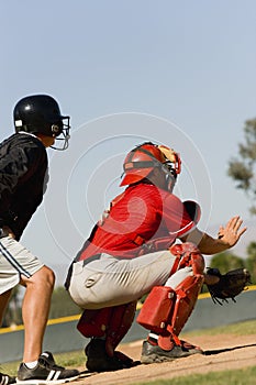 Baseball catcher and umpire on field