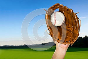 Baseball caught in glove outdoors