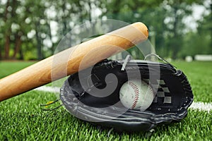 Baseball equipments on green field outdoors