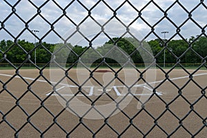 Baseball Field through Chain Link Fence on Cloudy Day
