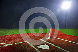 Baseball field at night with bright floodlights photo