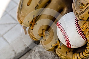 Baseball game mitt and ball on home plate / base