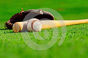 Baseball glove with ball and bat