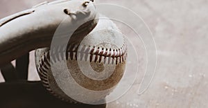 Baseball glove and ball with blurred background