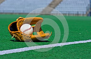 Baseball glove and ball on the field
